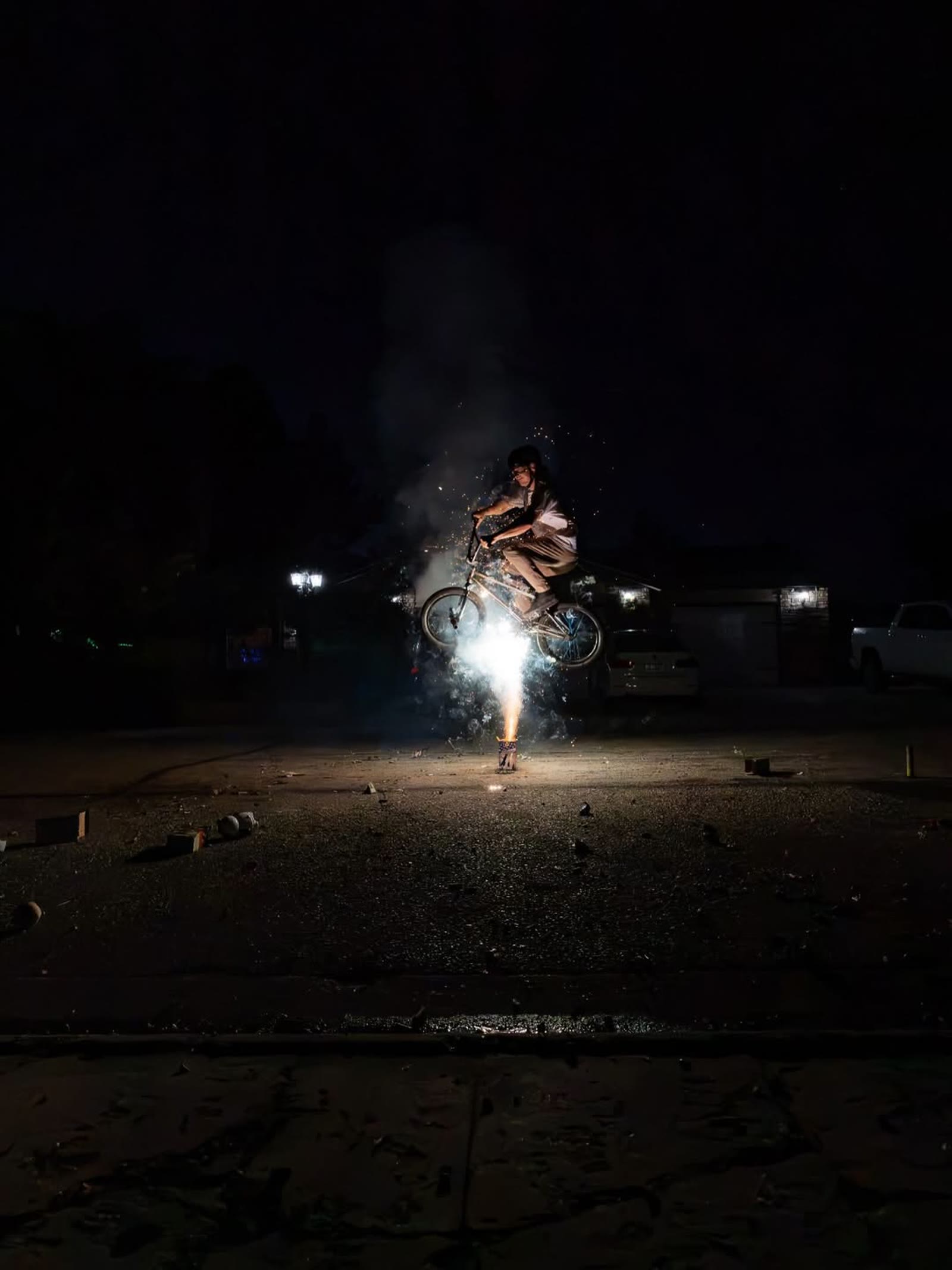 Melville Smith riding at night through a shower of sparks